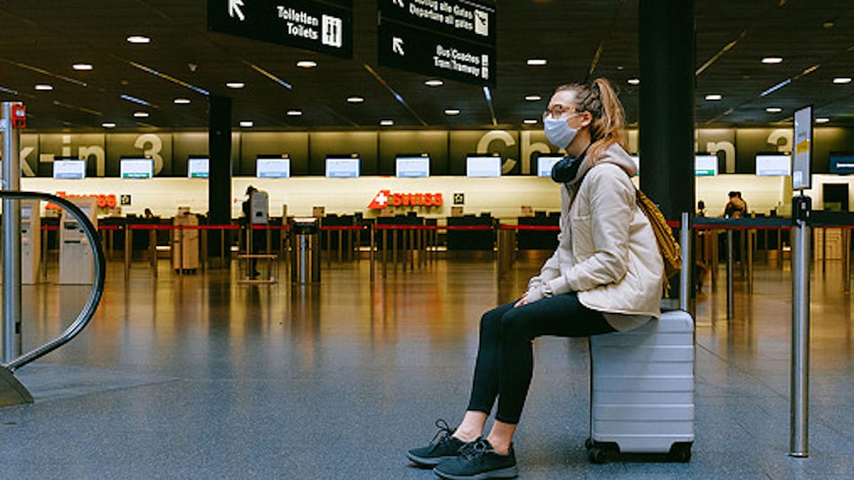 woman-sitting-on-luggage